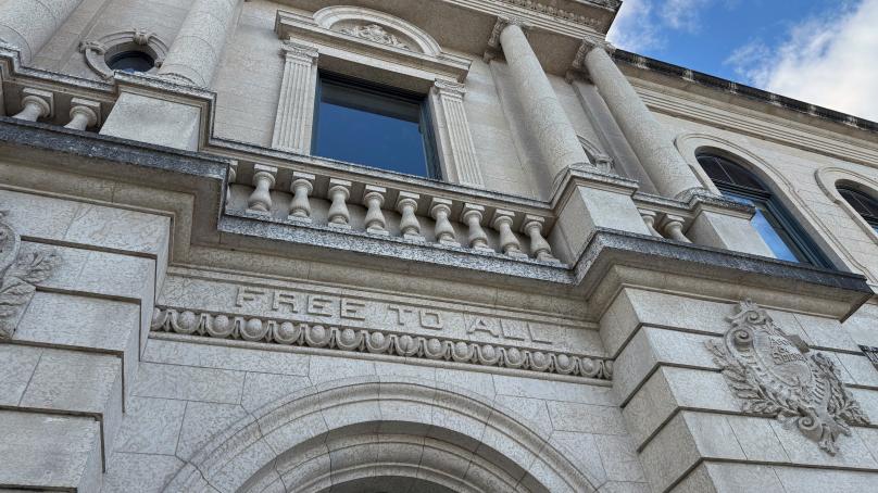 Exterior of the Carnegie Library with "Free to All" above the door