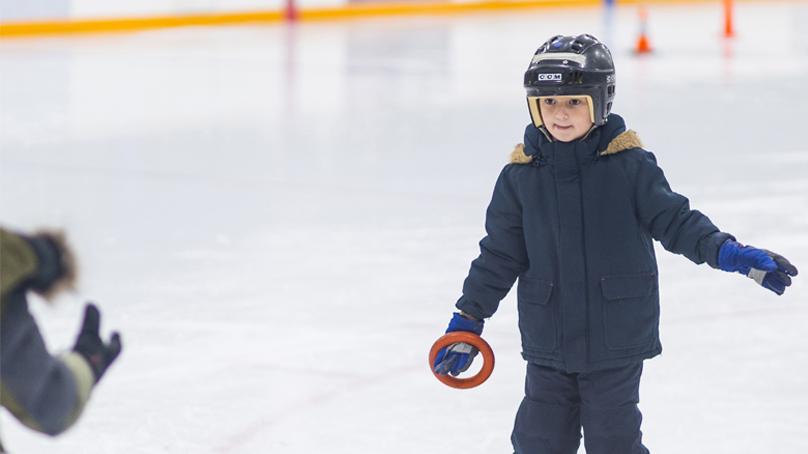 Child Skating with ring in hand