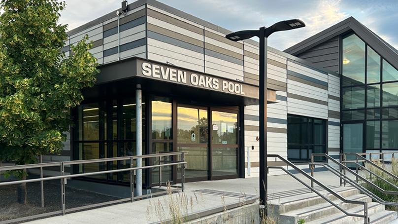 Seven Oaks Pool is spelled out in white letters above the main doors.