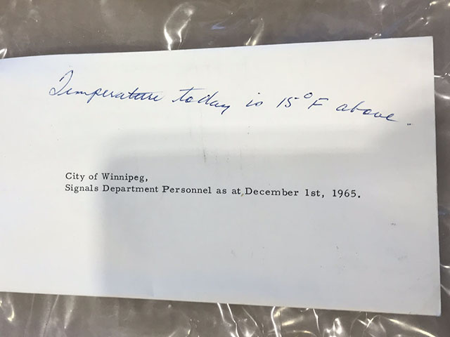 Envelope from time capsule with date, location and temperature written on it