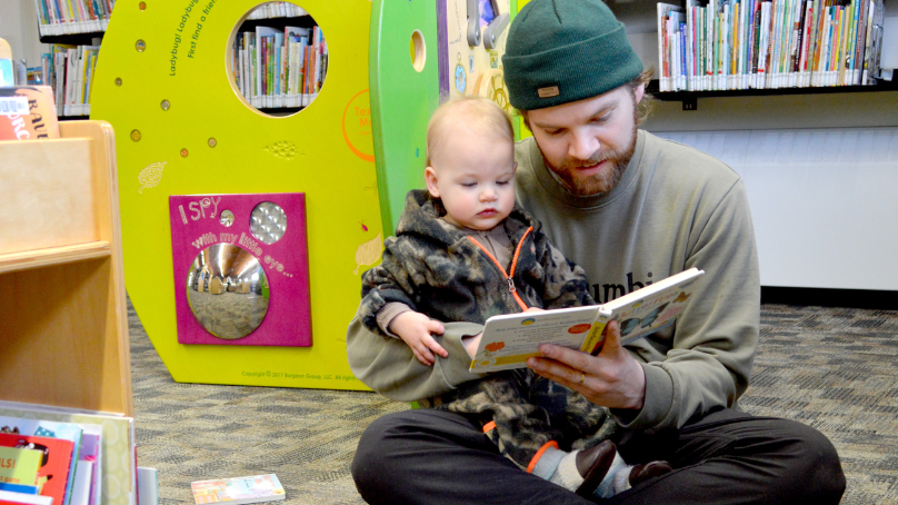Father and child reading a book