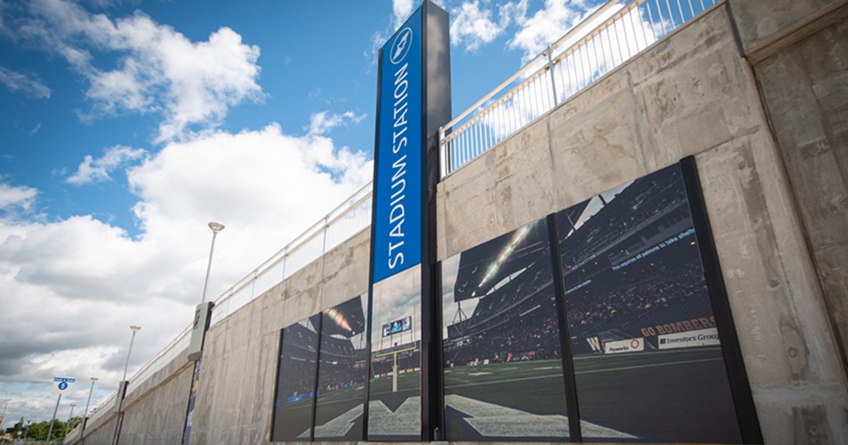 A Winnipeg Transit stop displays a poster of a Winnipeg Blue Bombers game