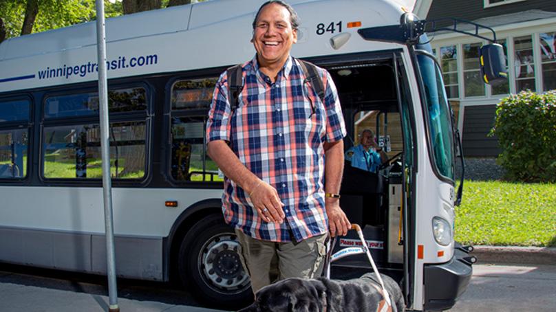 man with service dog getting off a tranisit bus