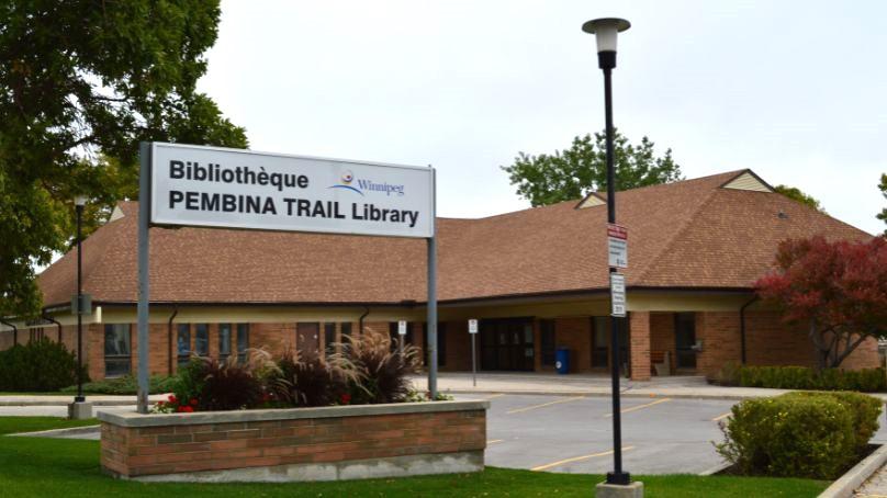 entrance to the Pembina Trail library showing sign and parking lot