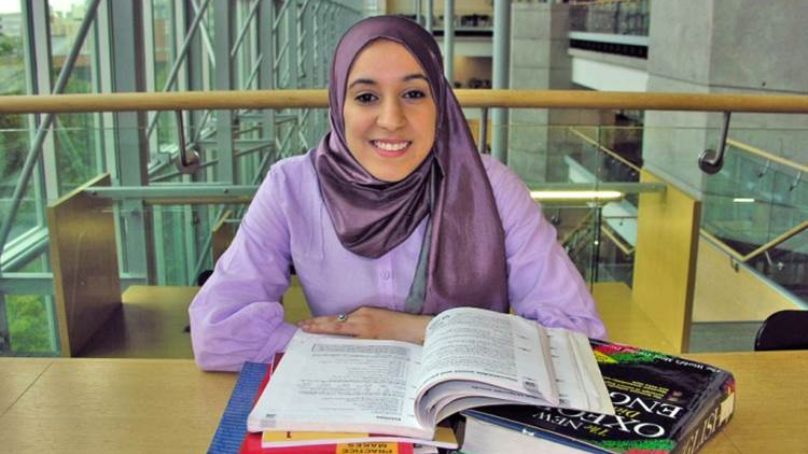 Woman sitting at the library with open books
