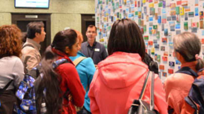 A group of people gather for a library tour