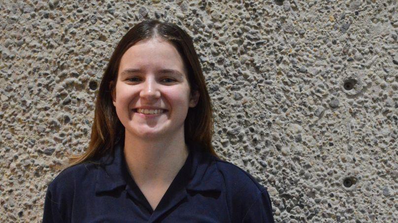 Community Crisis Worker, Toni, standing inside the Millennium Library