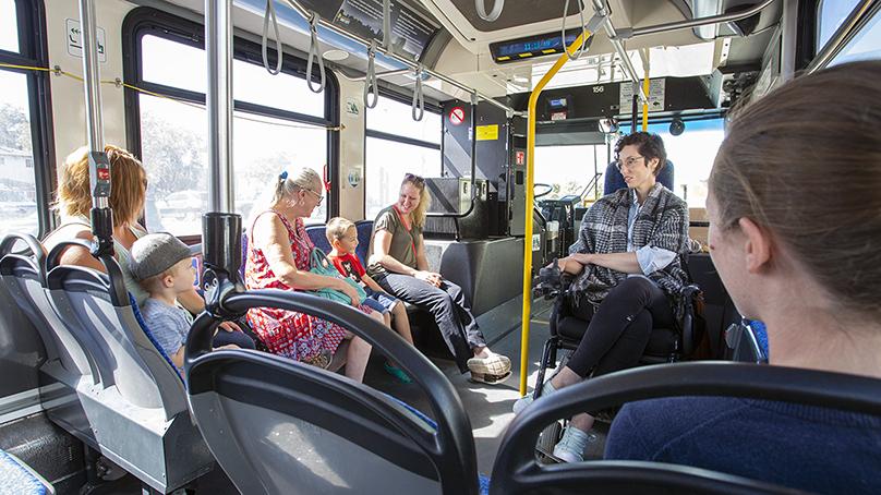 people of various ages and abilities riding a bus