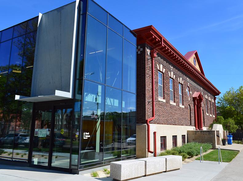 Glassed in area added to an old brick building