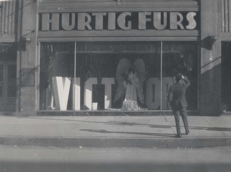 A street view of Hurtig Furs, formerly at 262 Portage Avenue, prominently shows a victory sign in the display window.