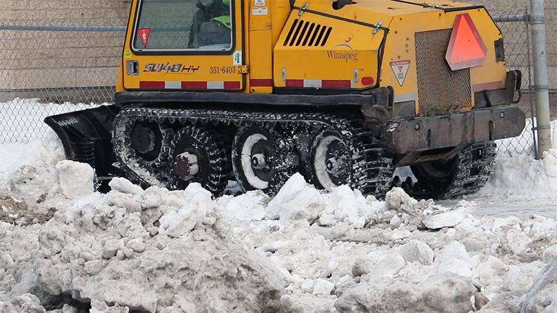 A plow clearing a sidewalk in Winnipeg.