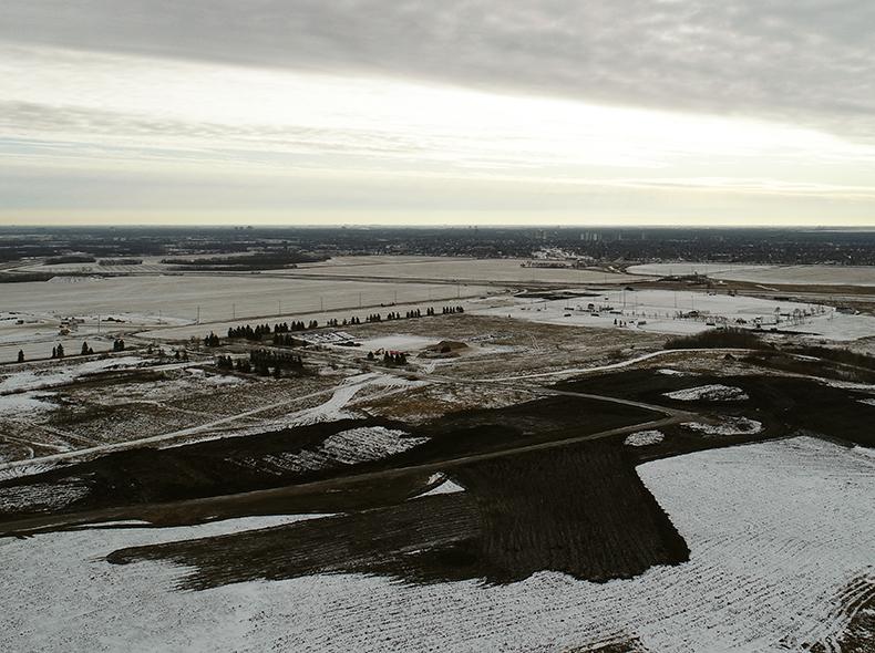 Fabricated soil is spread on the closed Summit Road Landfill.