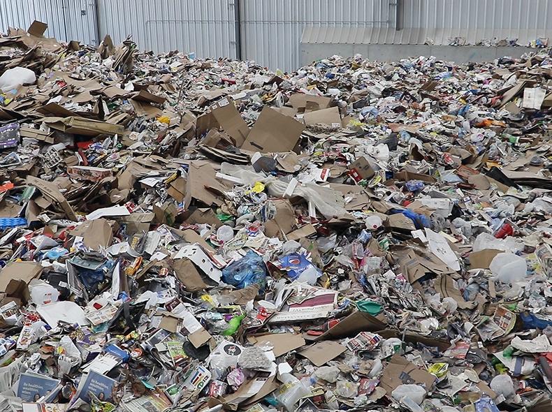 The recycling trucks dump the recyclables before they are sorted.