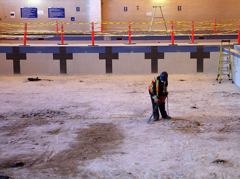 Crews remove the old tile so concrete rehabilitation work can be done.