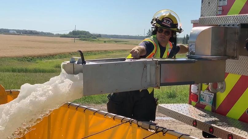 Portable tanks are set up at a fire scene to hold the water in areas without fire hydrants.