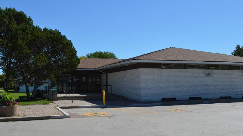 entrance to the Westwood library on Allard avenue showing parking lot and trees