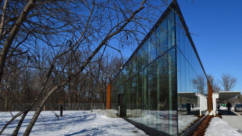 exterior of the windsor park library showing glass window walls and thin snow