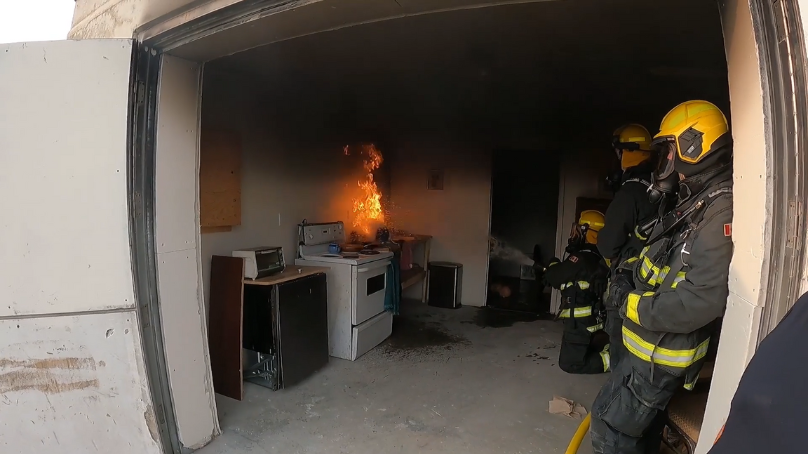 Firefighters work on a kitchen fire at the fire investigations training site