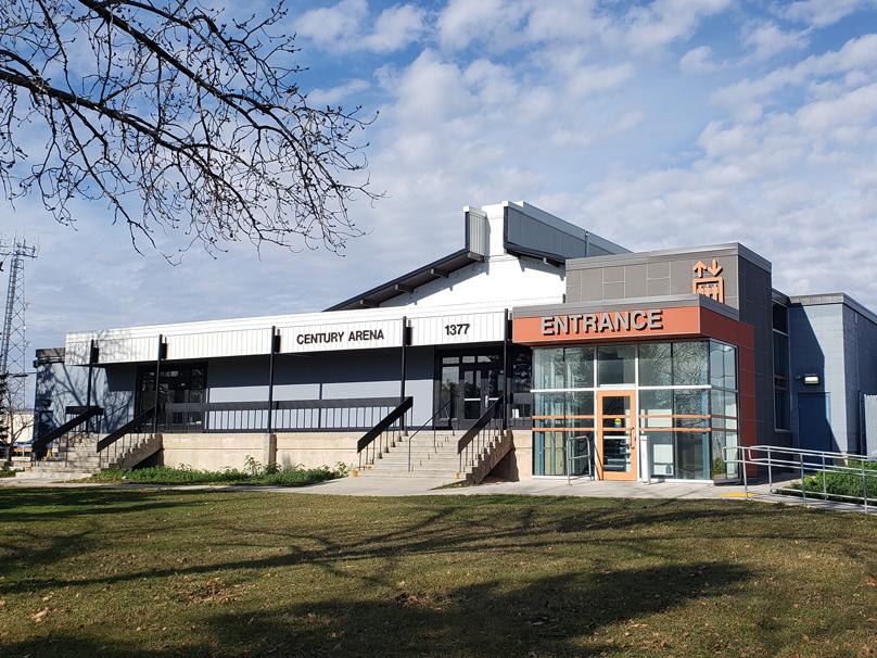 The front entrance of Century Arena under clouds and blue skies on a late fall day