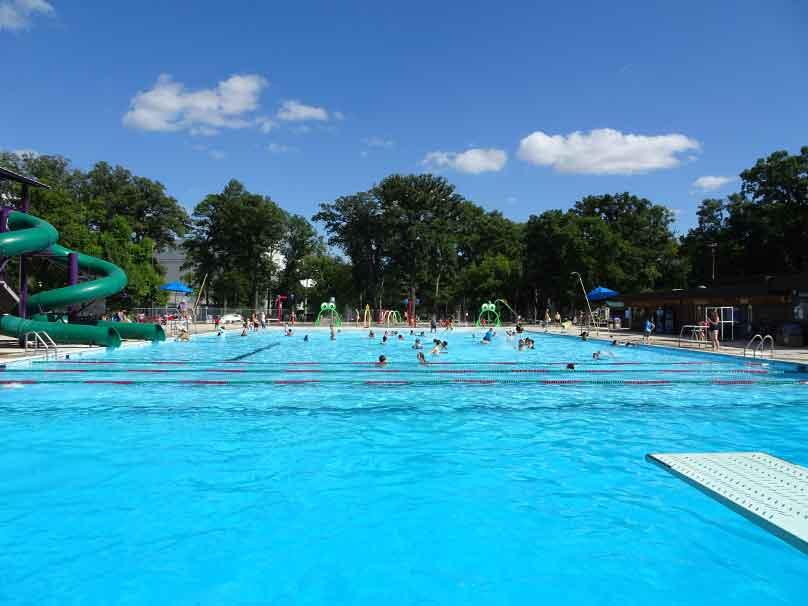 Swimmers enjoy Kildonan Park Pool on a clear sunny day.
