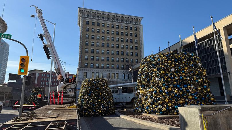 The tree arrives at City Hall pre-decorated in large sections.